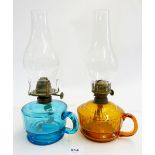 A Victorian turquoise glass finger lamp and an orange one