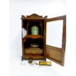 An Edwardian oak smokers cabinet with fitted interior, tobacco pot and dish, 42cm tall