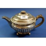 An early 19th century silver squat gadrooned teapot with flower finial, 872g, London 1807, by Daniel