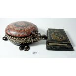 A lacquer tortoise form box, 26cm long and a Chinoiserie metal mounted notepad