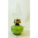 A Victorian green glass finger lamp with purple inclusions