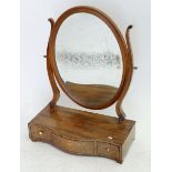 A George III mahogany oval dressing table mirror with three drawers to base and inlaid banding, 44 x