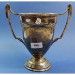A silver two handled trophy cup with engraved presentation for 'The Best Tractor Ploughman