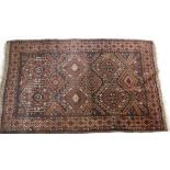 A Turkoman style rug with lozenge and hooked medallions on a brown ground 202 x 125cm