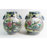 A pair of Chinese vases painted peacocks and flowers, 24cm