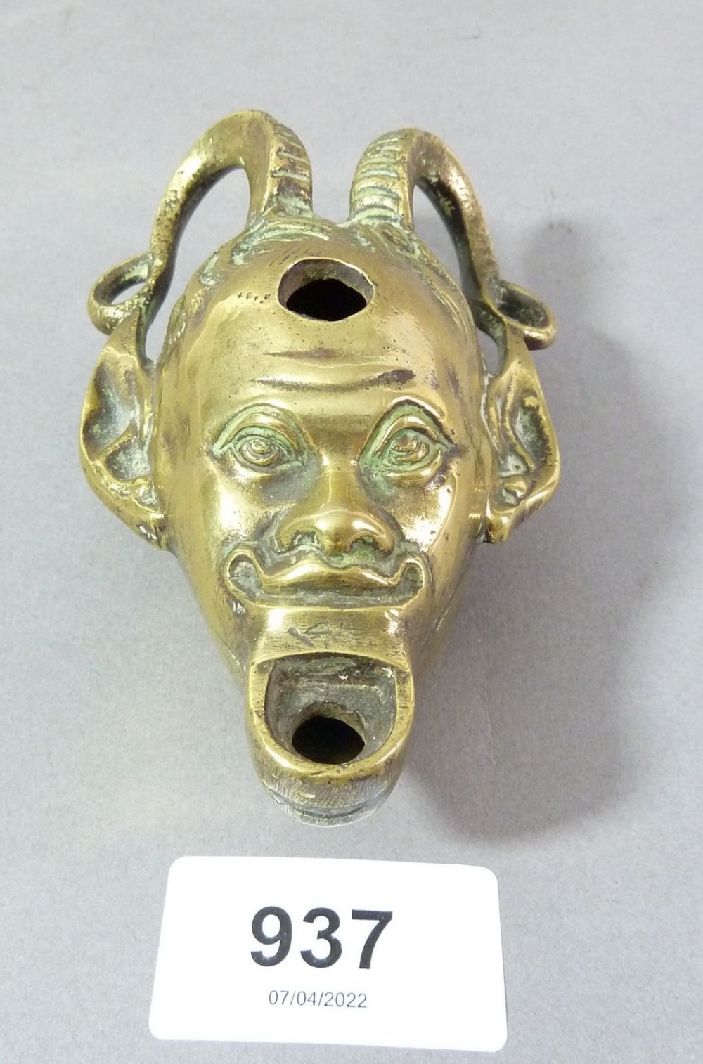 A brass satanic head oil lamp, 11cm