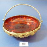 A cranberry glass bowl in gilt metal vine cast stand