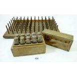 A set of metal number punches and a bobbin holder