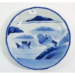 A Japanese blue and white charger painted mandarin ducks in a pond, four character mark to base,