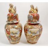 A pair of Japanese Satsuma vases and covers with Kylin lion finials, 27cm tall