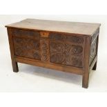 An 18th century oak coffer with incised decoration to front panels and frieze, 123cm wide