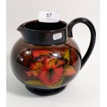 A Moorcroft flambe jug painted orchid, 12cm with paper label