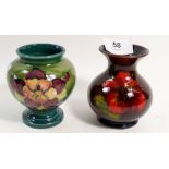 A Moorcroft small vase painted orchid on a green ground with paper label, 9cm and a hibiscus one