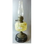 A Victorian oil lamp with mottled glass reservoir