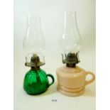 A Victorian pink opaque glass finger lamp and a green one