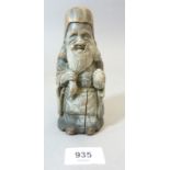 A Chinese 18th or early 19th century carved hard wood figure of an old man holding his beard, 40cm