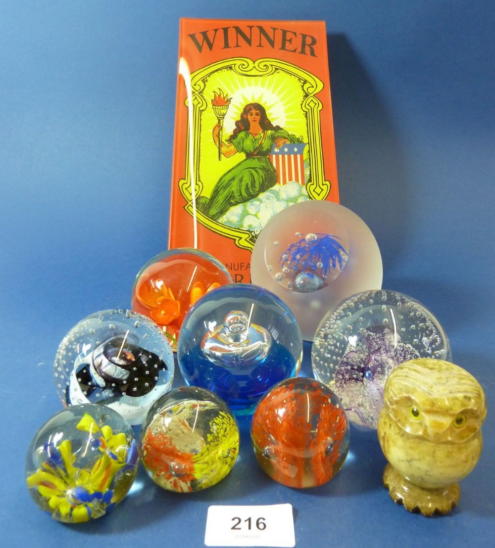 A collection of glass paperweights and a glass advertising plate 'Winner' by Windsor Broom Co