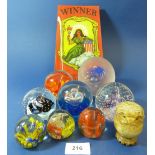 A collection of glass paperweights and a glass advertising plate 'Winner' by Windsor Broom Co