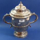 A large George III silver two handled trophy cup and lid with engraved crest, 1604g, London 1769,