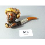A Meerschaum pipe in the form of a woman in a hat with silver collar and amber mouthpiece,
