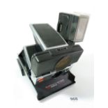 A Polaroid SX70 land camera with flash