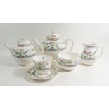A Royal Worcester floral tea service comprising: two teapots, six cups and saucers, six tea