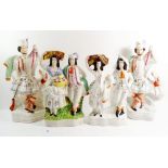 Two large Victorian Staffordshire groups Scottish huntsmen with dogs, 37cm tall and two couples