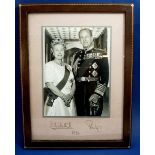 A photograph of the Queen and Prince Phillip with signatures, in leather easel frame