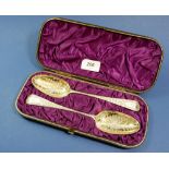 Two George III silver gilt serving spoons with later engraved bird decoration, cased, 102g