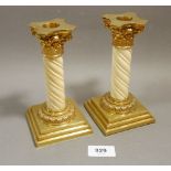 A pair of fine antique ivory spiral turned candlesticks with gilt metal Corinthian column mounts,