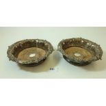 A pair of silver plated and wood turned bottle coasters, 18cm diameter