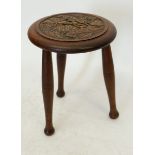 An oak Arts and Crafts style three legged stool carved poppies, 34cm tall