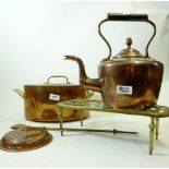 A copper oval two handled cooking pot, a copper kettle, brass trivet and jelly mould