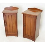 A pair of Edwardian walnut bedside cabinets with tongue and groove doors