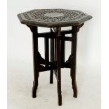 An Indian octaganal occassional table with carved decoration and folding stand, 46cm diameter