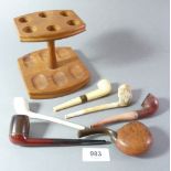 A wooden pipe stand with six pipes including horn, Bewley etc.