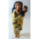 A Skookum Native American doll with baby, 27.5cm high