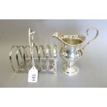 A French silver toast rack, 87g and a Georgian silver cream jug (dented), 86g