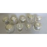 Nine various silver and glass toiletry jars