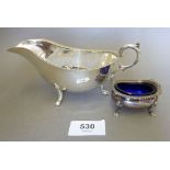 An unmarked silver sauce boat, 90g and a silver salt with glass liner, Birmingham 1964