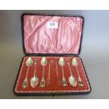 A set of six silver teaspoons plus tongs with decorative pierced terminals, Birmingham 1913 by WD