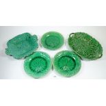 Three Wedgwood Majolica green leaf plates and two other Majolica serving dishes