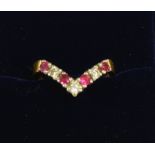 An 18 carat gold ruby and diamond wishbone ring, size K