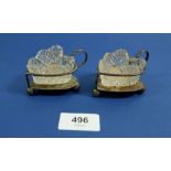 A pair of Walker and Hall silver plated and cut glass heart form salts