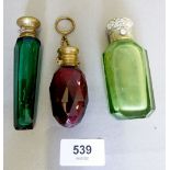 A Victorian green glass smelling salts bottle, a red glass scent bottle on chain and a green faceted