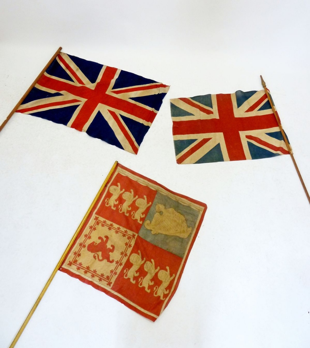 Two Union Jack flags on poles and a flag bearers standard flag