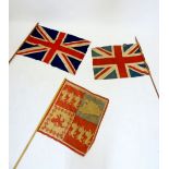 Two Union Jack flags on poles and a flag bearers standard flag