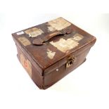 An antique leather hat box with shipping labels