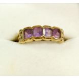 A 9 carat gold ring set four amethysts and six white stones, size L-M