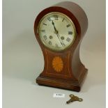 An Edwardian mahogany balloon form mantel clock with satinwood paterae, 29cm